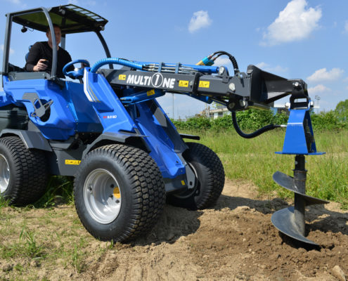 auger attachment for mini loader in action