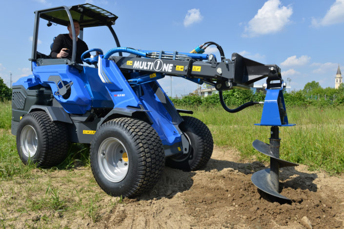 auger attachment for mini loader in action