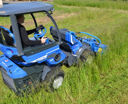 flail mower attachment for mini loader in action